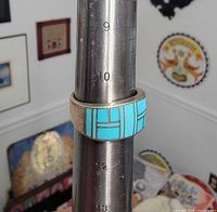 Ring on mandrel showing size 11 and turquoise inlay front