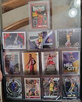 Full view of twelve sleeved LeBron James cards in binder page plus Beckett promo