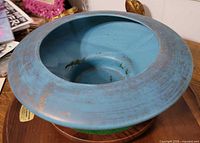 Top view of blue glazed shallow pedestal bowl showing interior cavity