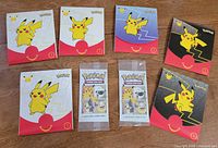 Eight sealed promo packs—six McDonald's paper sleeves and two General Mills plastic wrappers—laid out on table