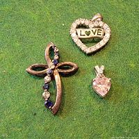 Front view of all three pendants on green background