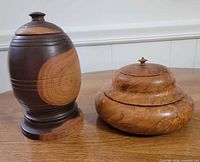 Both wood vessels with lids shown together