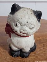 Front view of painted cast iron cat coin bank