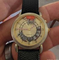 Front view of Valdann Lionel Train wristwatch showing dial graphics and hands