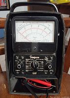Front view of Simpson 260 Series 6 multimeter in case with leads visible