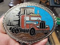 front view showing semi-truck design, turquoise inlay and braided edge