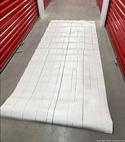 Full view of rolled-out vinyl backdrop showing overall size and plank pattern