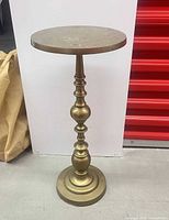 Full view of brass pedestal table showing top, column, and base