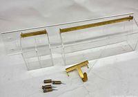 All components laid out: acrylic rail, valet, hook, mounting hardware