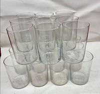 Group of clear cylindrical vases stacked