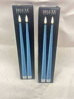 Two Deluxe Homeart boxes showing blue LED taper candles