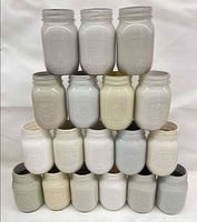 Front view of 20 stacked painted Mason jars showing colour range
