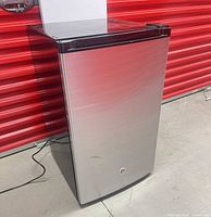 Front three-quarter view showing stainless steel door and overall condition