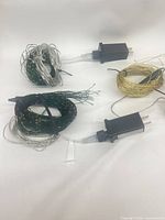 Four plug-in micro light bundles showing wire colors and AC adapters