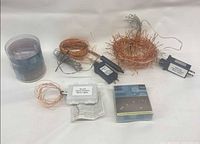 Overview of all five LED string-light sets with coils, adapters, battery packs, and packaging