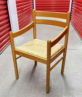 Front angled view showing full chair, wood frame, rush seat