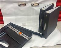 Group shot showing both paper trimmers, two binders and two clear clipboards