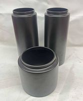 Overall view of three matte black porcelain vases