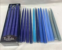 Candles in Twilight box beside loose candles in tray