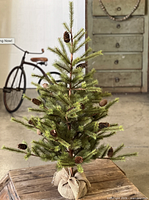 Full view of assembled tree with pine cones and burlap base