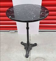 Full view of table showing marble top and pedestal base