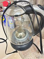 Full view of glass kettle with cord and handle