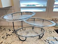 Overall view of 3-tier serving tray with all glass platters mounted on black metal stand