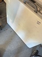 Table folded upright showing overall surface and sticker