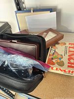 Overall view showing board game box, dominoes case, card set bag and puzzle sleeve