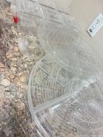 Group of round and rectangular clear plastic trays and lids