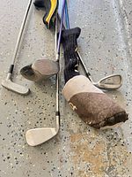 Group of clubs and headcovers on floor