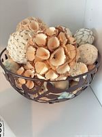 Overall view of metal bowl filled with decorative balls