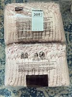 Front view of two sealed bundles labeled Depend showing MaxSold tag