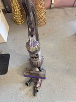 Full view of Dyson Ball Animal 2 vacuum with attachments on floor