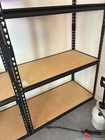 Full view of shelving unit showing three shelves and steel frame