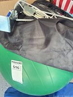 Green stability ball with black cover and pulley bracket visible