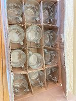 Open box showing twelve partitioned snowflake glass mugs