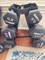 Front view of rack showing 5 lb, 10 lb and 15 lb dumbbells