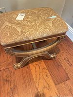 Three-quarter view displaying wooden frame and scrolled stretcher