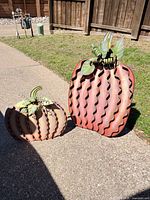 Front view of both metal pumpkin decorations