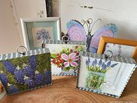 Group view showing all plaques, framed pieces, and butterfly