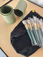 Brush holder, pouch, several brushes in sleeves