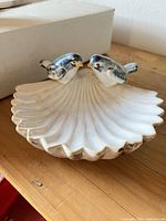 Front view of ceramic seashell dish with two birds