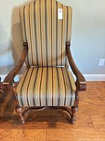 Front view showing full chair, wood frame and striped upholstery