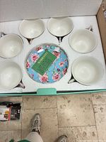 Open box showing six teacups in foam insert