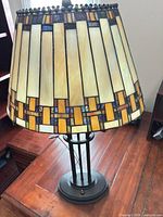 Full view of lamp showing stained glass shade and metal base