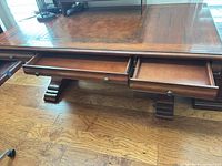 Open drawers showing leather inlay top and drawer hardware