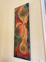 Full view of vertical abstract painting mounted on wall