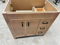 Front view of vanity showing doors, drawers, handles, finish, and overall style