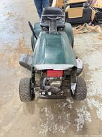 Front view of green Craftsman mower, hood removed exposing engine